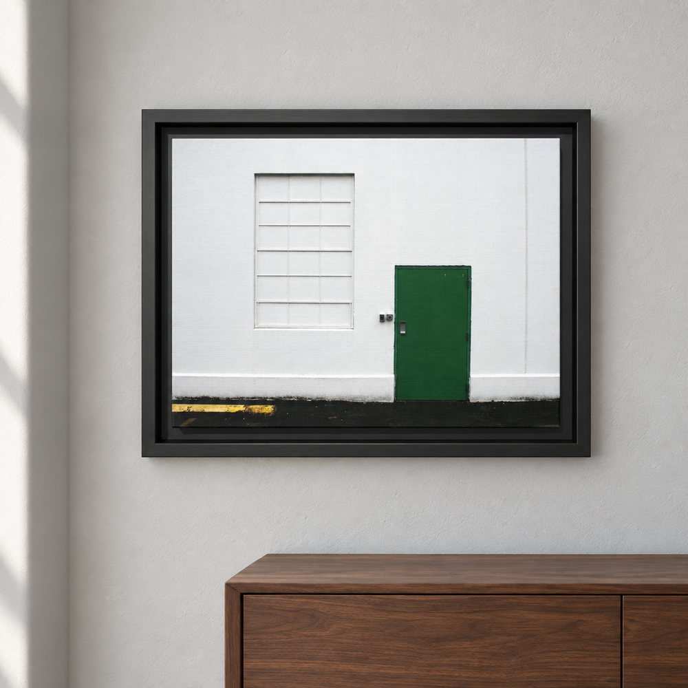 Minimalism + Green black framed canvas on a pale wall beside a walnut cabinet; styled room mockup.